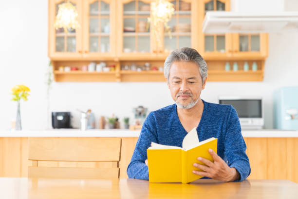 istock elderly man who reads a book, 1360282594