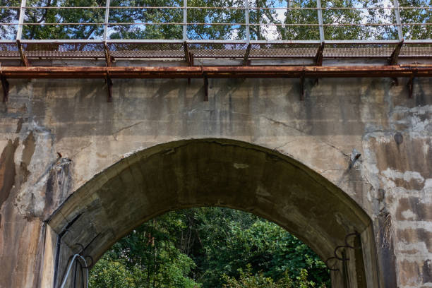 istock Concrete arched vault, passage under the railway towards the forest. 1360287415