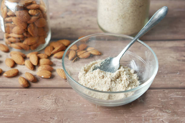 istock almond powder and almond in a jar on table, 1360287425