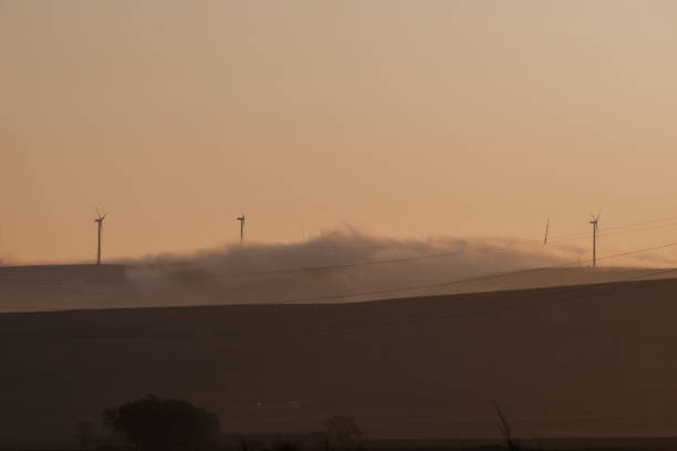 Clouds enveloped the wind turbines. In the twilight of the dawn.