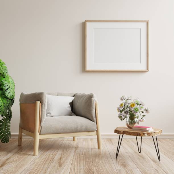 istock Square frame poster mockup with armchair and green plants on white wall background. 1360290867