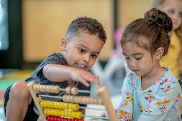 istock Group of Preschool Students Playing Together 1360291980
