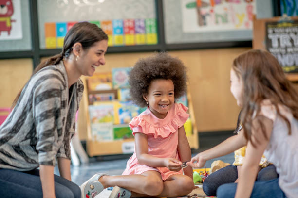 istock Preschool Students Playing with their Teacher 1360291997