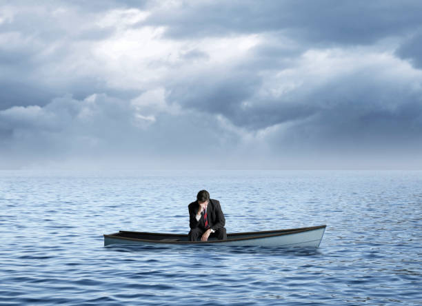 istock Dejected Man Sitting In Sinking Row Boat 1360292597