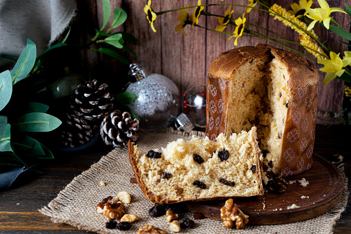 Chopped view of a typical Italian panettone or cut sweet bread and the portion where you can see the dried fruits inside at Christmas. Typical Christmas food.