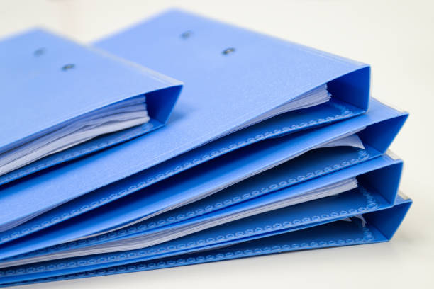 istock file folder and Stack of business report paper file on the table 1360298225