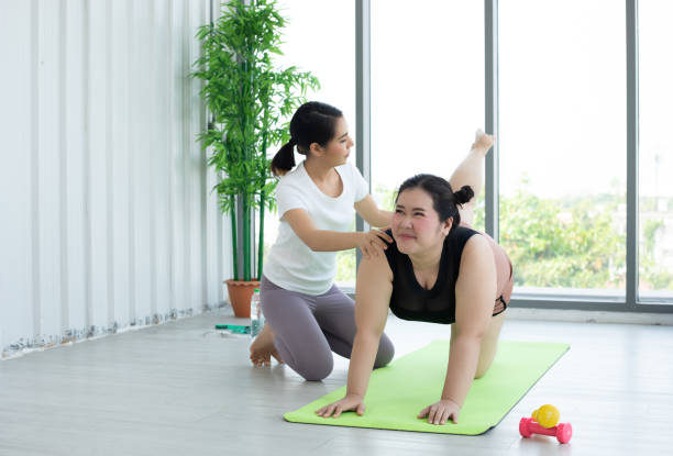 istock Two Asian woman watching and learning yoga exercising online on computer notebook laptop at home ,concept activity and relax at home 1360299901