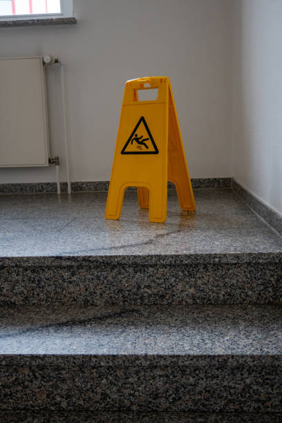istock yellow sign warns against slipping in a staircase 1360300942