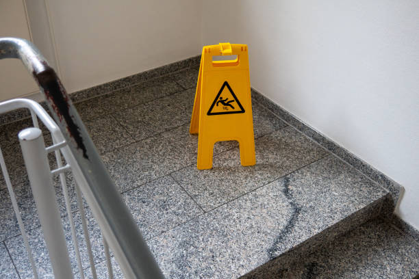 istock yellow sign warns against slipping in a staircase 1360300944