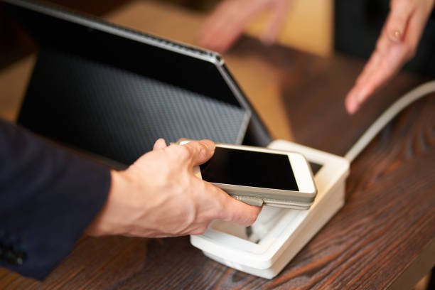 istock Hands of men making cashless payments 1360305242