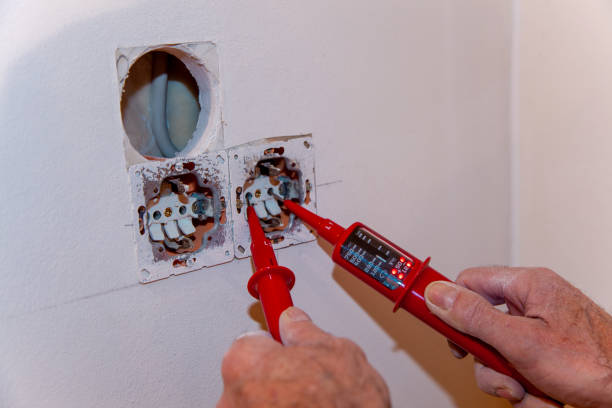 istock Hand of Electrician testing for electricity with a voltage tester. Electrician checking wall socket with voltage tester. 1360307796