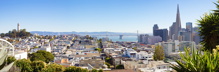 Wide elevated panoramic view of downtown San Francisco and Russian hill on a sunny Autumn morning with extended view of Bay bridge in the background.