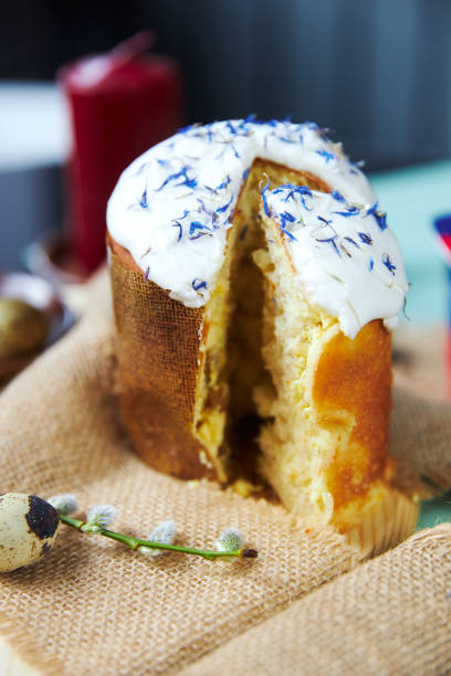 istock Easter cake with white glaze strewn with cornflowers petals 1360314286