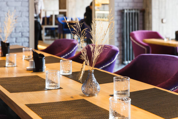 istock Table in the restaurant on which there are empty glasses and a vase, serving 1360314512
