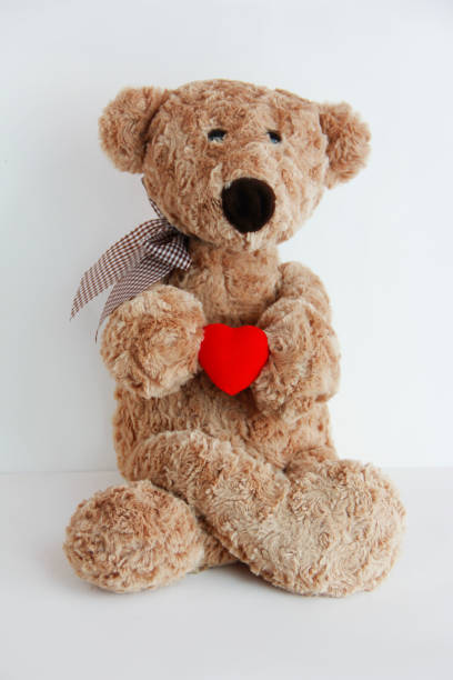 istock soft toy bear holding a red heart 1360316702