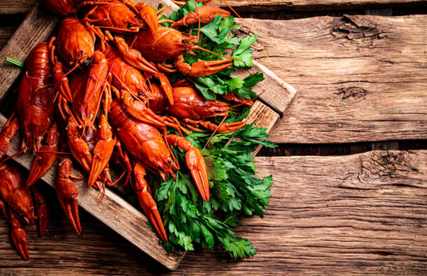 istock Boiled crayfish with parsley on the tray. 1360320401