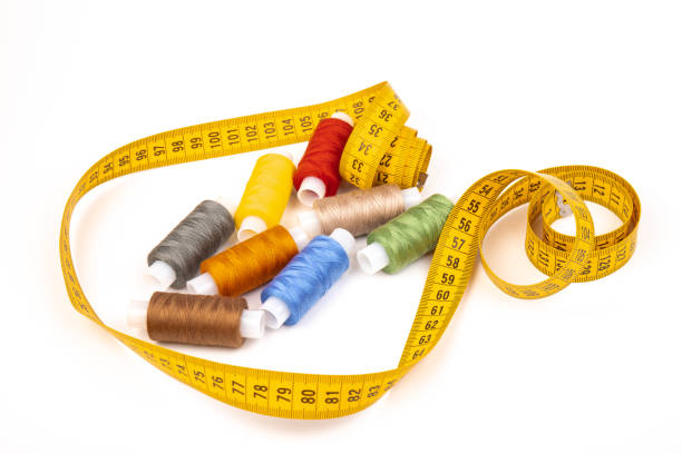 istock Sewing threads, sewing centimeter or measuring tape, isolated on white background. 1360321028