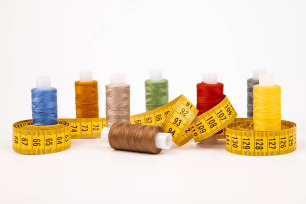 istock Sewing threads, sewing centimeter or measuring tape, isolated on white background. 1360321719
