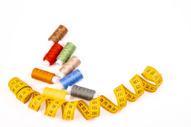 istock Sewing threads, sewing centimeter or measuring tape, isolated on white background. 1360321835