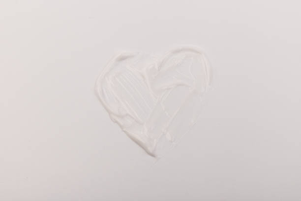 istock White smear of cosmetic cream isolated on light background. 1360322456