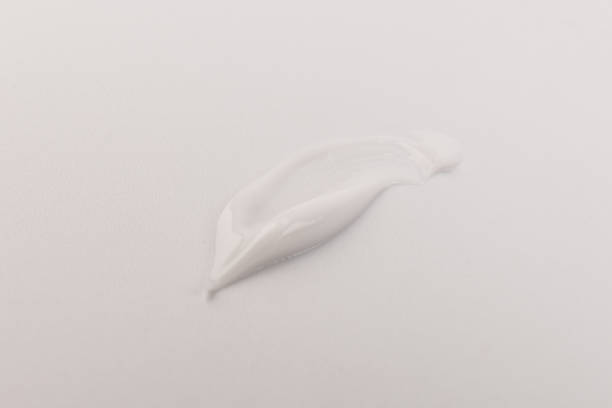 istock White smear of cosmetic cream isolated on light background. 1360322459