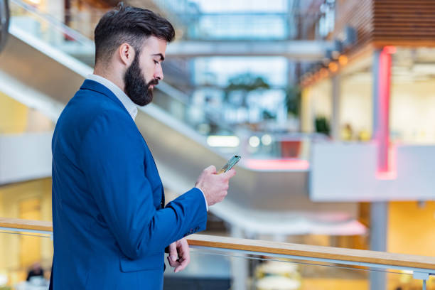 istock Business man in the hall using mobile phone 1360323308