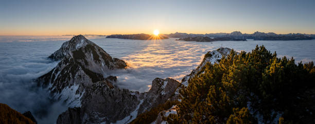 Berchtesgaden Alps at sunrise over a sea of clouds, Zwiesel summit cross, Bad Reichenhall, Bavaria, Germany Berchtesgaden Alps at sunrise over a sea of clouds, Zwiesel summit cross, Bad Reichenhall, Bavaria, Germany berchtesgaden national park photos stock pictures, royalty-free photos & images