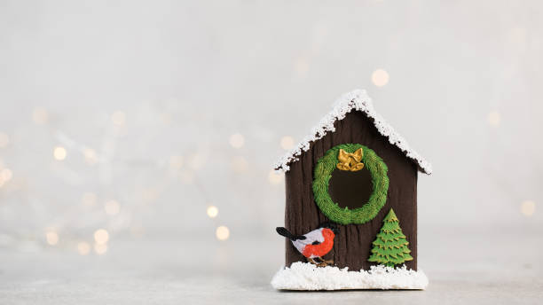 istock Christmas composition with a birdhouse and christmas lights. Copy space. 1360323723