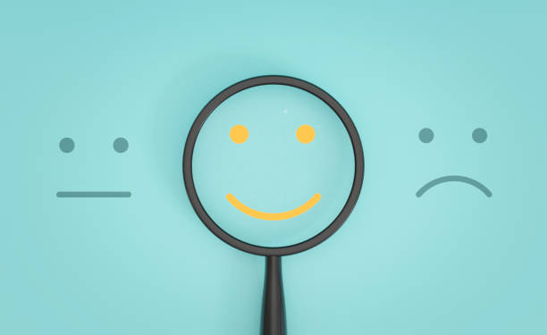 Yellow smile face inside of magnifier glass between sad and normal emotion for focus positive emotion concept. Yellow smile face inside of magnifier glass between sad and normal emotion for focus positive emotion concept. customer retention stock pictures, royalty-free photos & images