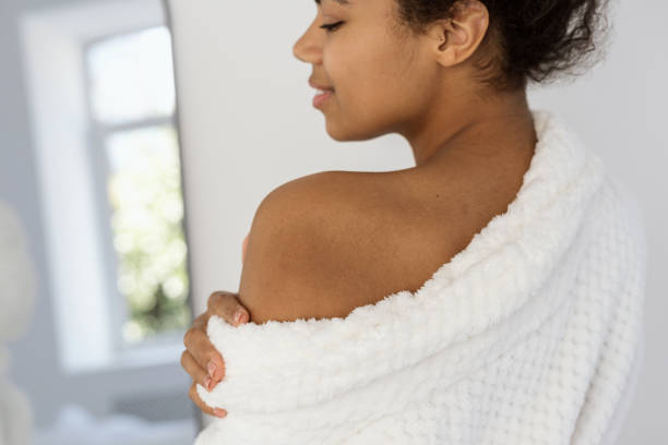 istock Young african american woman wearing in bathrobe 1360324617