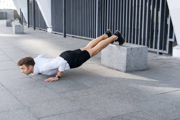 istock Young sportsman standing in low plank pose, training outdoors 1360324623