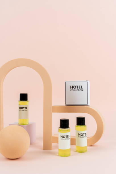hotel toiletry collection close to geometric shapes - hotel shampoo stockfoto's en -beelden