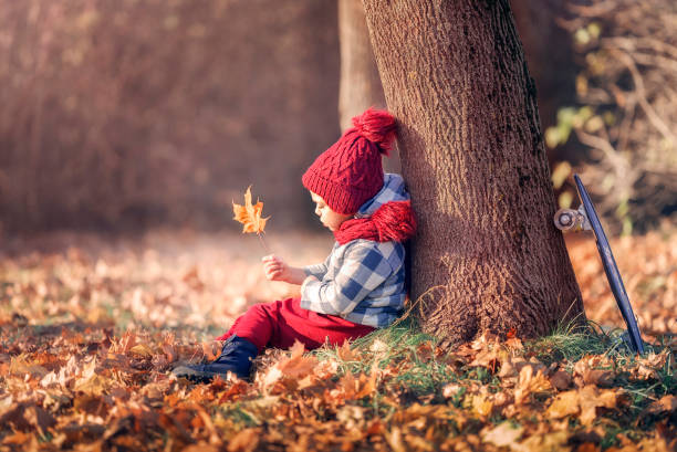 istock A boy is sad in the park in autumn 1360326609