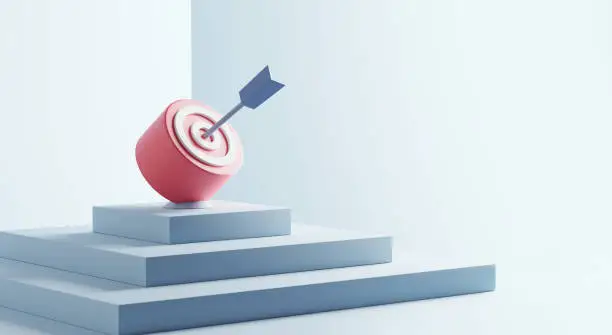 Photo of Blue arrow hit the center of target or goal of success on top of the staircase. Business target achievement concept.