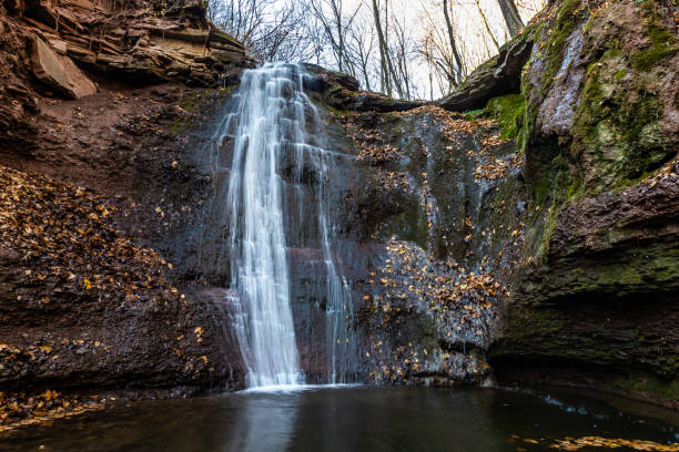 istock Tranquil waterfall scenery in the middle of autumn forest 1360328280