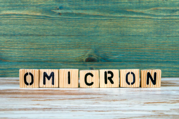 istock OMICRON. Letters on a white and green wooden background 1360330057
