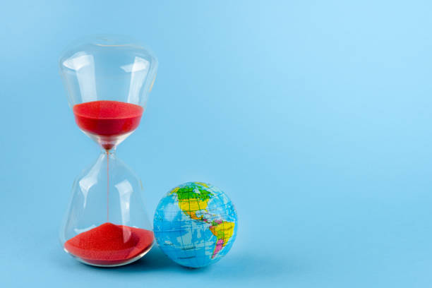 istock Hourglass with red sand photographed in studio. Wasted time concept 1360331969