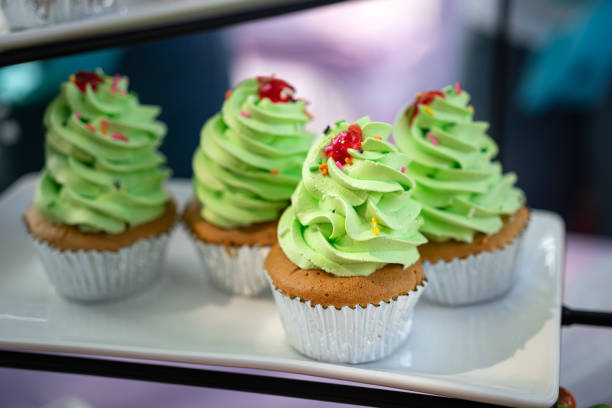Set of colorful cupcake bakery is prepared on the table for service in premium buffet meal, food product object photo. Close-up and selective focus at front piece.