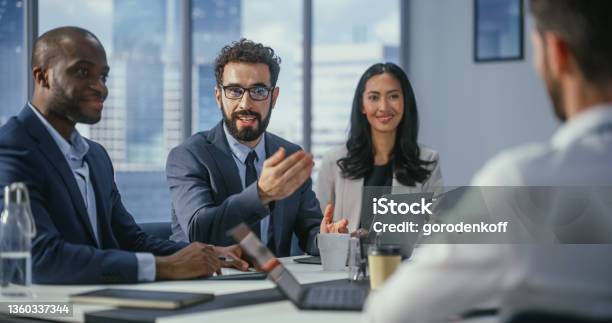 Multiethnic Office Conference Room Meeting Diverse Team Of Top Managers Talk Brainstorm Use Computers Businessman Presenting Investment Strategy To Partners Closeup Portrait Stock Photo - Download Image Now