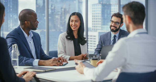 istock Multi-Ethnic Office Conference Room Meeting: Diverse Team of Top Managers, Executives, Share Digital Tablet Computer Talk. Businesspeople Discuss Strategy, do Analysis. 1360337350