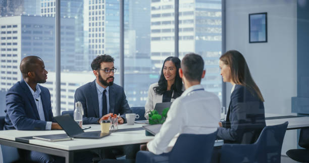 istock Modern Multi-Ethnic Office Conference Room Meeting: Diverse Team of Managers, Executives Talk, Brainstorm, Use Computers. Businesspeople Discuss Investment Strategy in e-Commerce Startup. 1360337355
