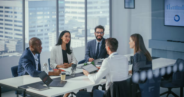 istock Modern Multi-Ethnic Office Conference Room Meeting: Diverse Team of Ambitious Top Managers, Executives Talk, Brainstorm, Use Tablet. Businesspeople Discuss Investment Strategy in e-Commerce Startup 1360337358
