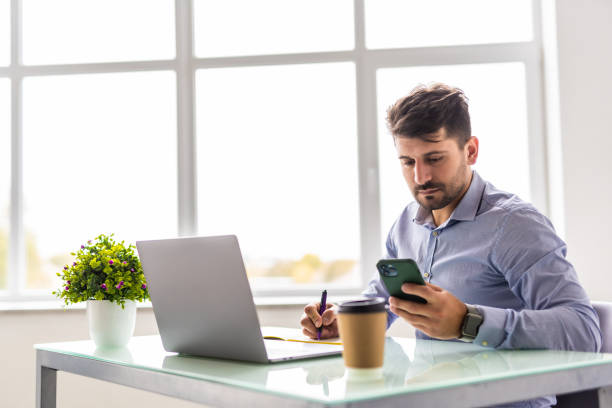 istock Multi-tasking young businessman working in the office. 1360340125