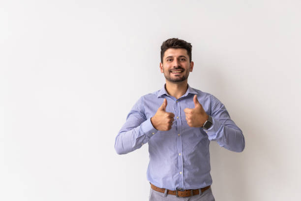 istock Happy man giving thumbs up sign on white background 1360340326