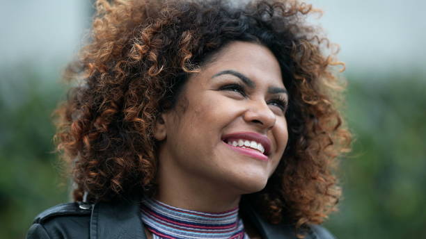 istock Ecstatic woman feeling happy looking at sky. Joyful person with HOPE 1360340343