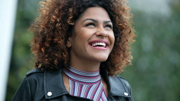 istock Ecstatic woman feeling happy looking at sky. Joyful person with HOPE 1360340394