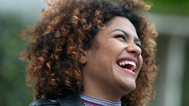 istock Ecstatic woman feeling happy looking at sky. Joyful person with HOPE 1360340431
