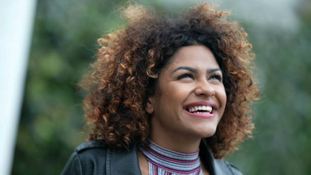 istock Ecstatic woman feeling happy looking at sky. Joyful person with HOPE 1360340522