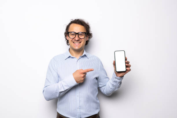 istock Confident Man Showing a Mobile Phone White Background 1360341387