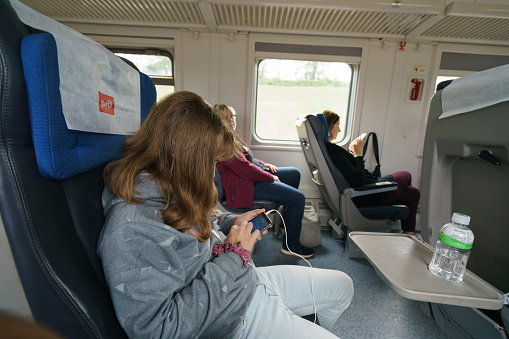 Moscow, Russia - August 16, 2019: Interior of carriage of long distance train. Traveller's sitting on the chairs. Econom class, low-cost ticket concepts, good value for money. Touristic lifestyles